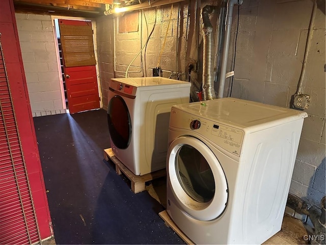 washroom with washing machine and clothes dryer and laundry area