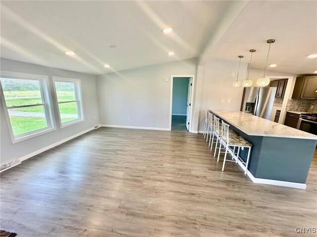 4850 Palmer Rd, Lee, NY 13471 - kitchen with baseboards, backsplash, a kitchen bar, and stainless steel appliances