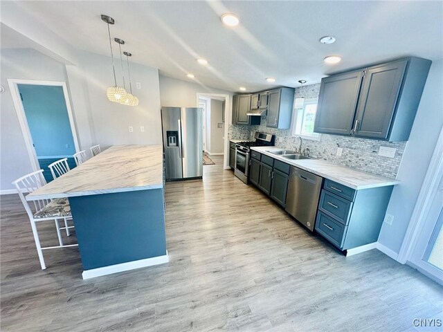 4850 Palmer Rd, Lee, NY 13471 - kitchen with decorative backsplash, a peninsula, a kitchen bar, a sink, and stainless steel appliances