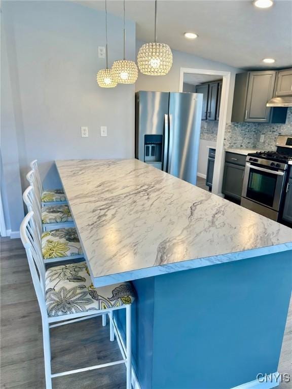 4850 Palmer Rd, Lee, NY 13471 - kitchen with under cabinet range hood, appliances with stainless steel finishes, wood finished floors, and tasteful backsplash