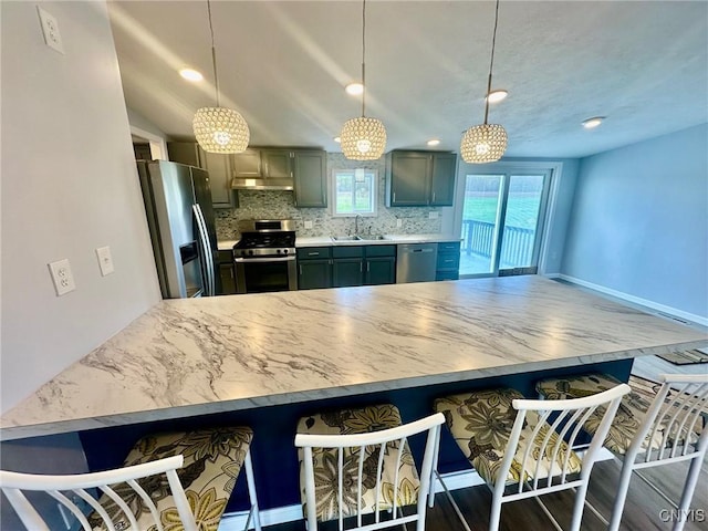 4850 Palmer Rd, Lee, NY 13471 - kitchen with appliances with stainless steel finishes, a sink, tasteful backsplash, under cabinet range hood, and pendant lighting