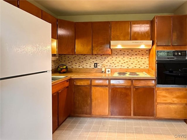 28 Concord Blvd, New Hartford, NY 13413 - kitchen with light countertops, decorative backsplash, under cabinet range hood, and white appliances