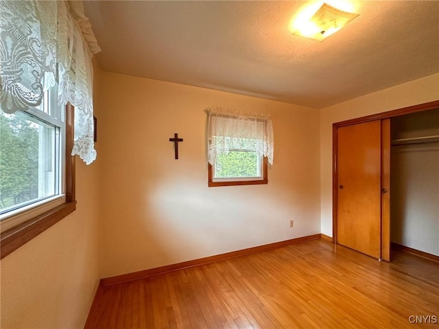 28 Concord Blvd, New Hartford, NY 13413 - unfurnished bedroom featuring baseboards, a closet, and light wood-type flooring
