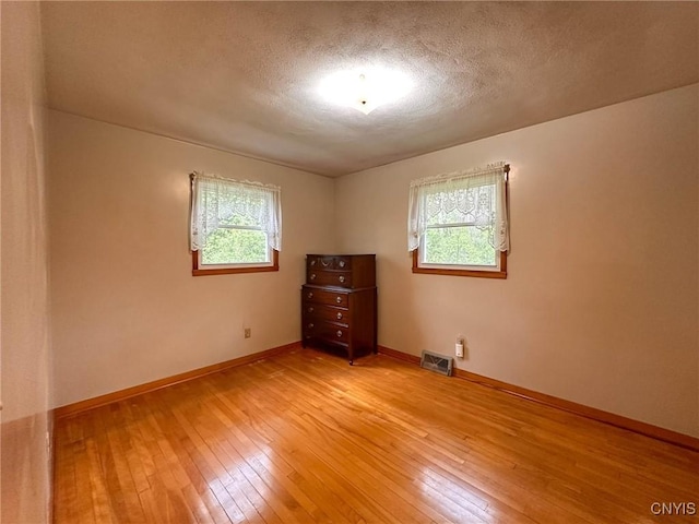 28 Concord Blvd, New Hartford, NY 13413 - spare room featuring plenty of natural light, light wood-type flooring, a textured ceiling, and visible vents