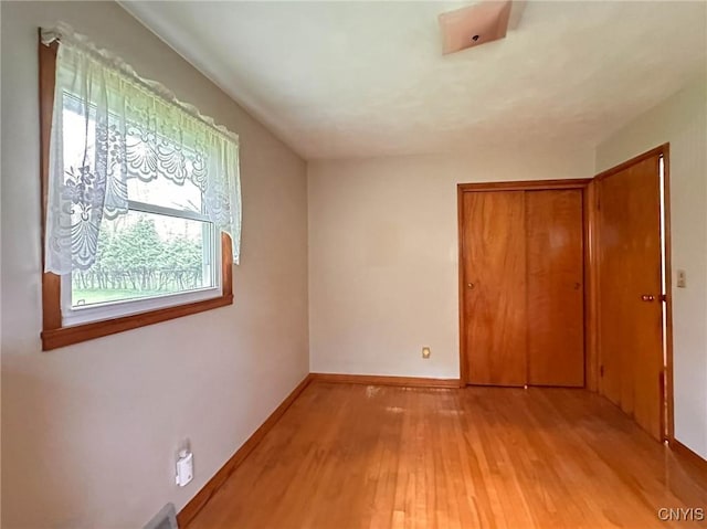 28 Concord Blvd, New Hartford, NY 13413 - unfurnished bedroom with baseboards, light wood finished floors, and a closet