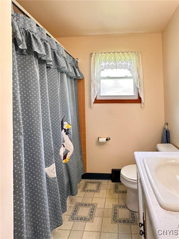 28 Concord Blvd, New Hartford, NY 13413 - full bathroom with vanity, tile patterned floors, a shower with curtain, and toilet