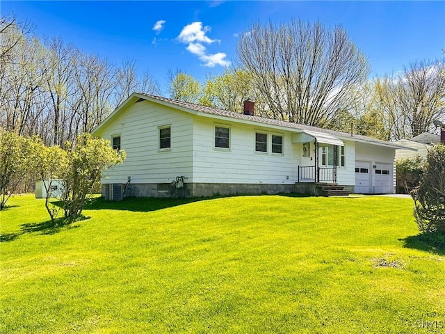 28 Concord Blvd, New Hartford, NY 13413 - rear view of property featuring a yard, an attached garage, and a chimney