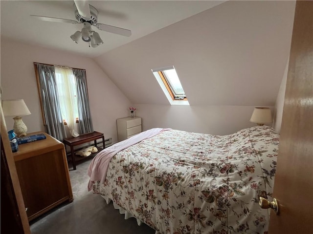 carpeted bedroom featuring ceiling fan and vaulted ceiling with skylight