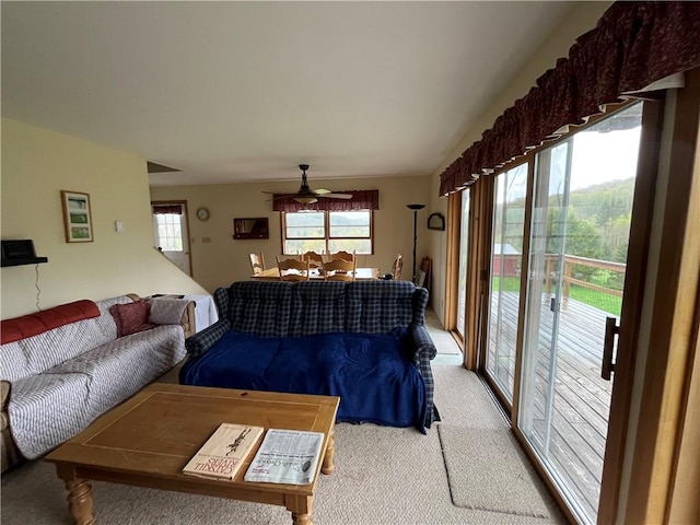 carpeted living room featuring ceiling fan