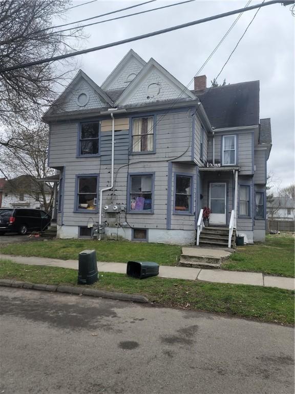 view of front of home featuring entry steps and a chimney