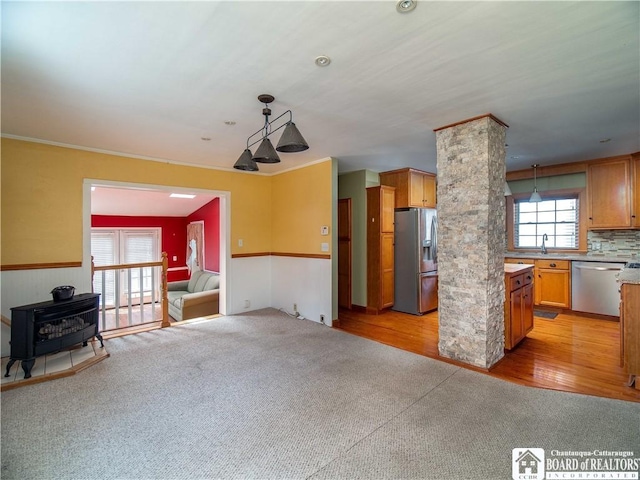53 W 5th St, Dunkirk-City, NY 14048 - kitchen featuring stainless steel appliances, light colored carpet, a sink, and a wood stove
