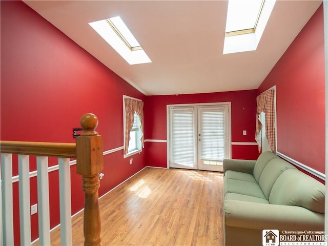 53 W 5th St, Dunkirk-City, NY 14048 - living area featuring french doors, lofted ceiling with skylight, and wood finished floors