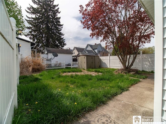 53 W 5th St, Dunkirk-City, NY 14048 - view of yard featuring an outdoor structure, a fenced backyard, and a storage shed