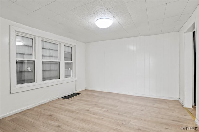 unfurnished room with visible vents and wood finished floors