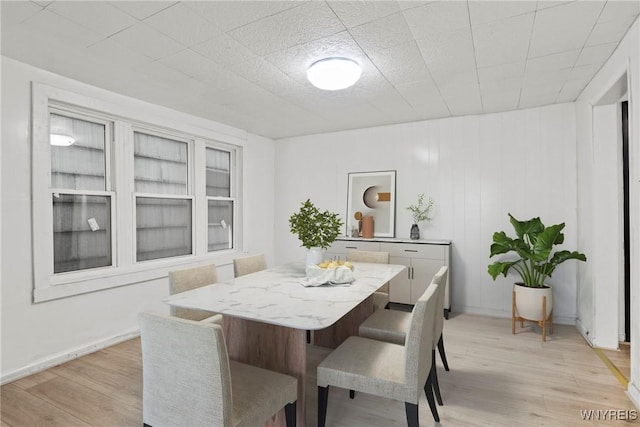 dining room featuring light wood-style floors and baseboards