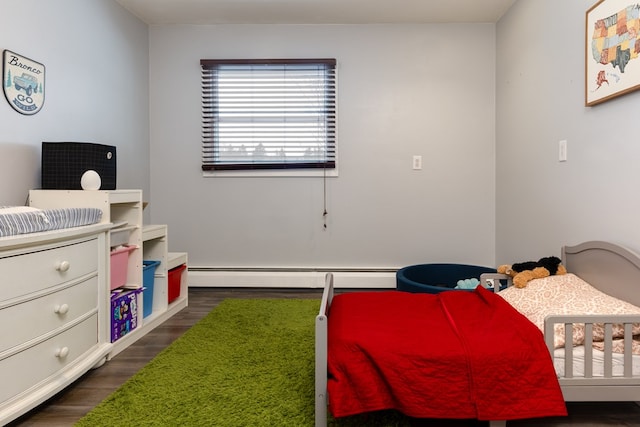 bedroom with a baseboard heating unit and dark wood-type flooring