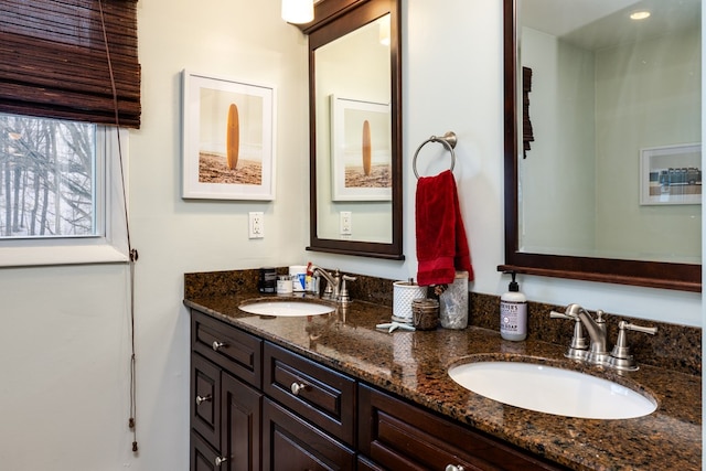 full bath with double vanity and a sink