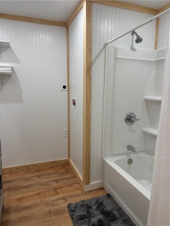 full bathroom with wood finished floors and shower / tub combo with curtain