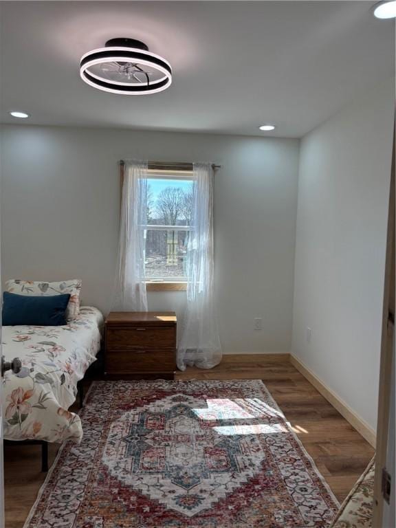 bedroom with baseboards, recessed lighting, and wood finished floors