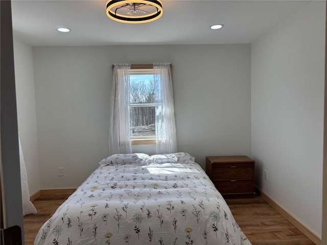 bedroom with recessed lighting, baseboards, and wood finished floors