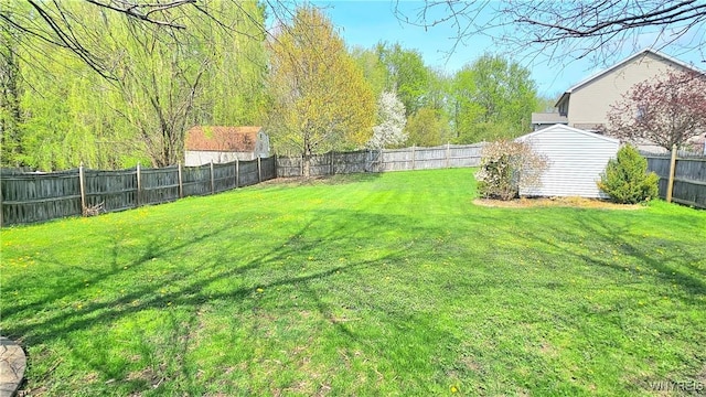 view of yard featuring a fenced backyard and an outdoor structure