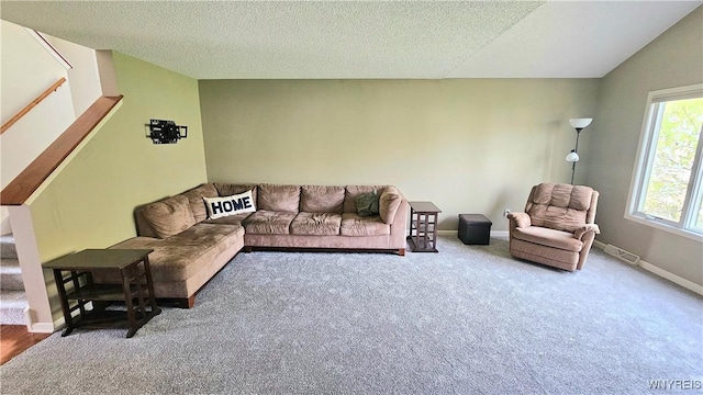 living room featuring a textured ceiling, stairway, visible vents, and carpet