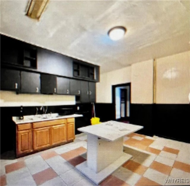 66 W Parade Ave, Buffalo, NY 14208 - kitchen with light countertops, open shelves, and brown cabinets