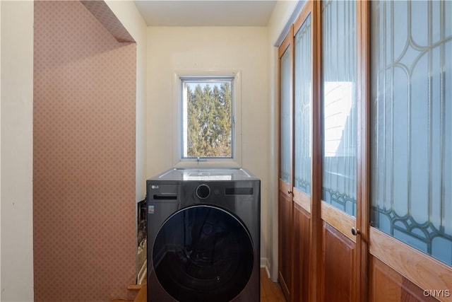laundry room with laundry area and washer / dryer