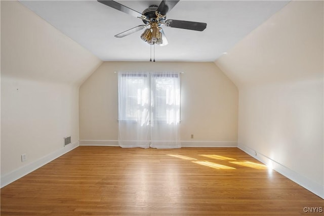 bonus room with visible vents, light wood-style flooring, ceiling fan, and vaulted ceiling