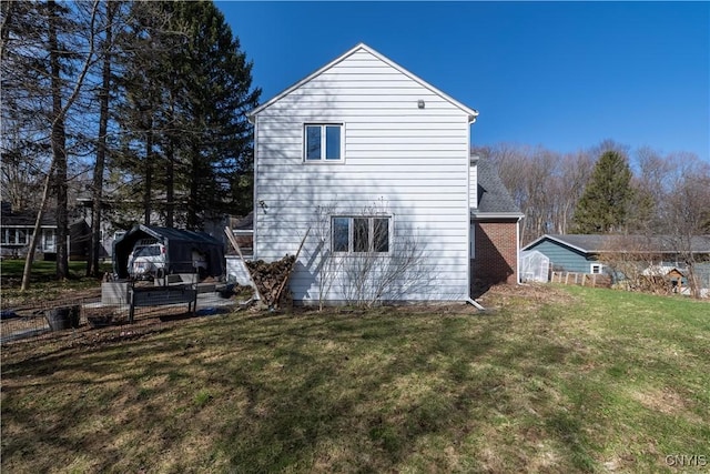 back of property featuring a lawn