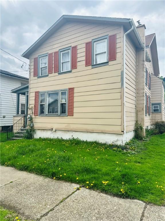 517 High St, Elmira-City, NY 14901 - view of side of home with a yard