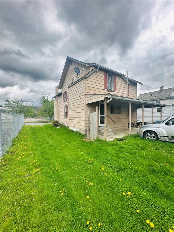 517 High St, Elmira-City, NY 14901 - view of property exterior with a lawn and fence