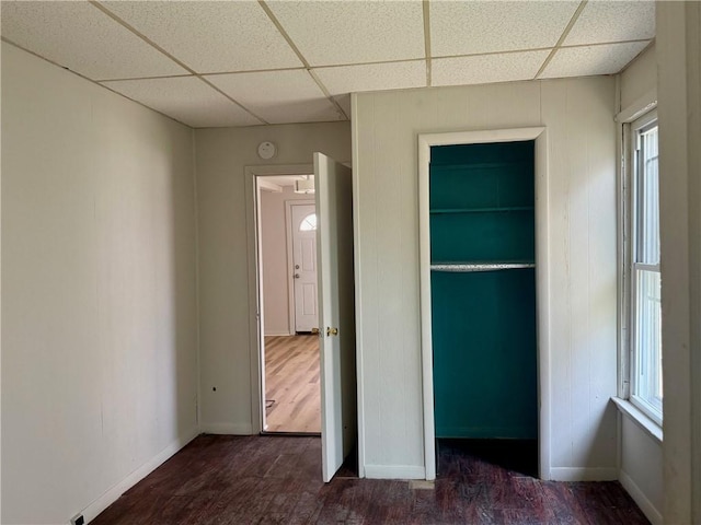 22 W Hazel St, Corning-City, NY 14830 - unfurnished bedroom with baseboards, a paneled ceiling, and wood finished floors