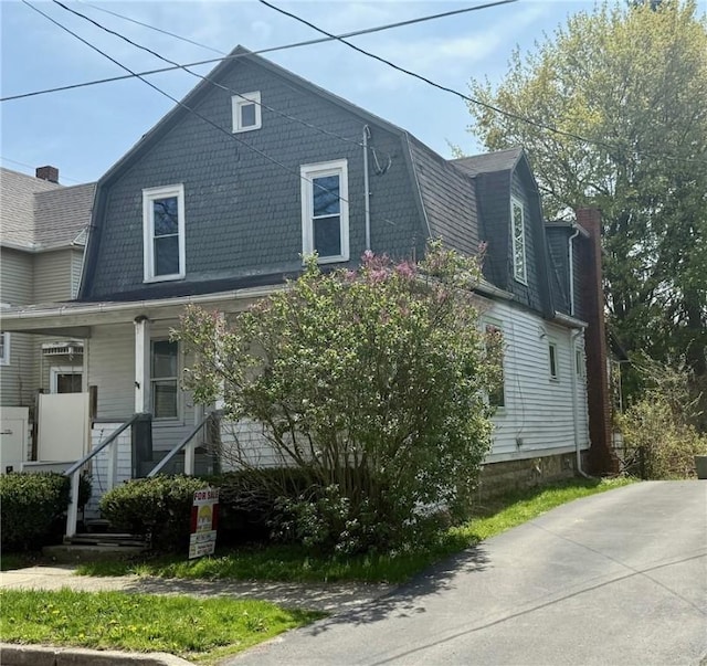 22 W Hazel St, Corning-City, NY 14830 - view of front of property with a porch, a gambrel roof, and a chimney