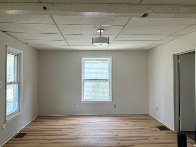 22 W Hazel St, Corning-City, NY 14830 - unfurnished room with plenty of natural light, light wood-style flooring, and a paneled ceiling