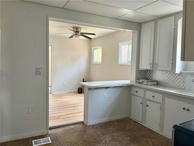 22 W Hazel St, Corning-City, NY 14830 - kitchen with visible vents, light countertops, baseboards, a peninsula, and white cabinetry