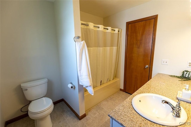 full bath with vanity, baseboards, shower / bath combo with shower curtain, and toilet