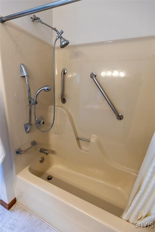 bathroom with shower / bathtub combination with curtain