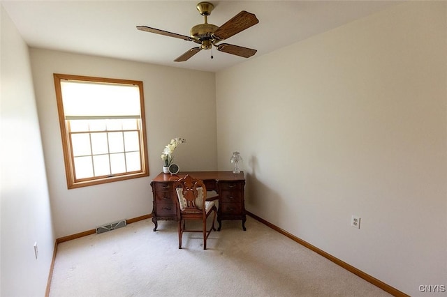office space with light colored carpet, baseboards, visible vents, and ceiling fan