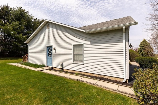 view of side of home with a yard