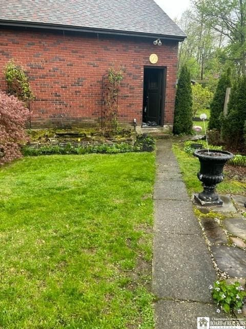 4 Brewer Pl, Westfield, NY 14787 - entrance to property featuring a lawn, brick siding, and roof with shingles