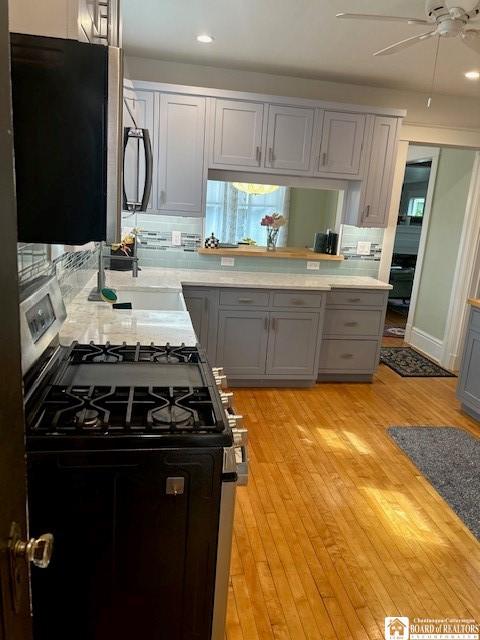 4 Brewer Pl, Westfield, NY 14787 - kitchen featuring gray cabinetry, decorative backsplash, ceiling fan, and range with gas cooktop