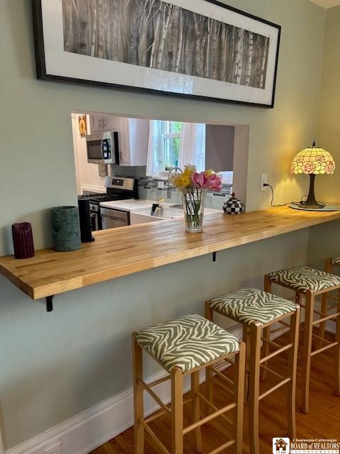 4 Brewer Pl, Westfield, NY 14787 - kitchen featuring wood counters, a kitchen breakfast bar, and stainless steel appliances