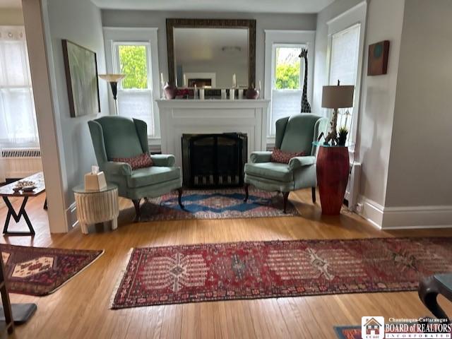 4 Brewer Pl, Westfield, NY 14787 - sitting room with radiator heating unit, baseboards, a fireplace, and wood finished floors