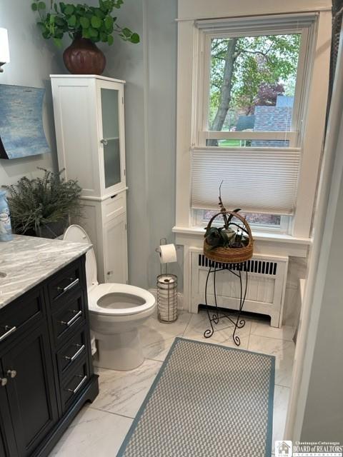 4 Brewer Pl, Westfield, NY 14787 - bathroom featuring vanity, marble finish floor, radiator heating unit, and toilet