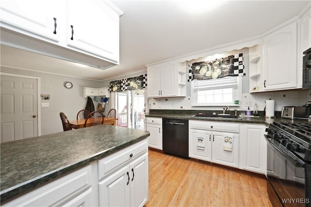 kitchen featuring a sink, dark countertops, black appliances, and white cabinetry
