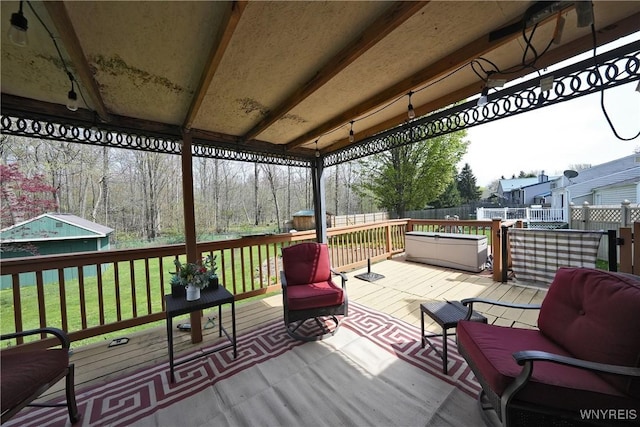 wooden deck featuring a yard and fence