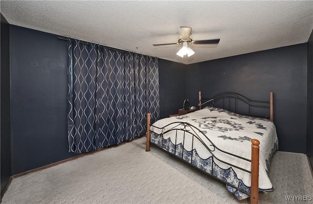 carpeted bedroom with a textured ceiling and ceiling fan