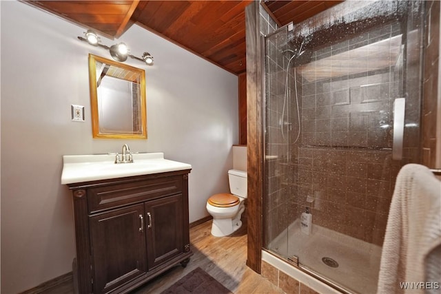 bathroom with vanity, wood finished floors, toilet, wood ceiling, and a stall shower