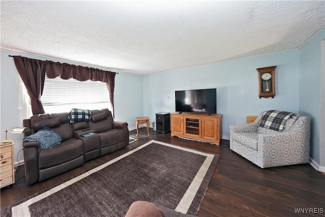 living room with baseboards, a textured ceiling, and wood finished floors